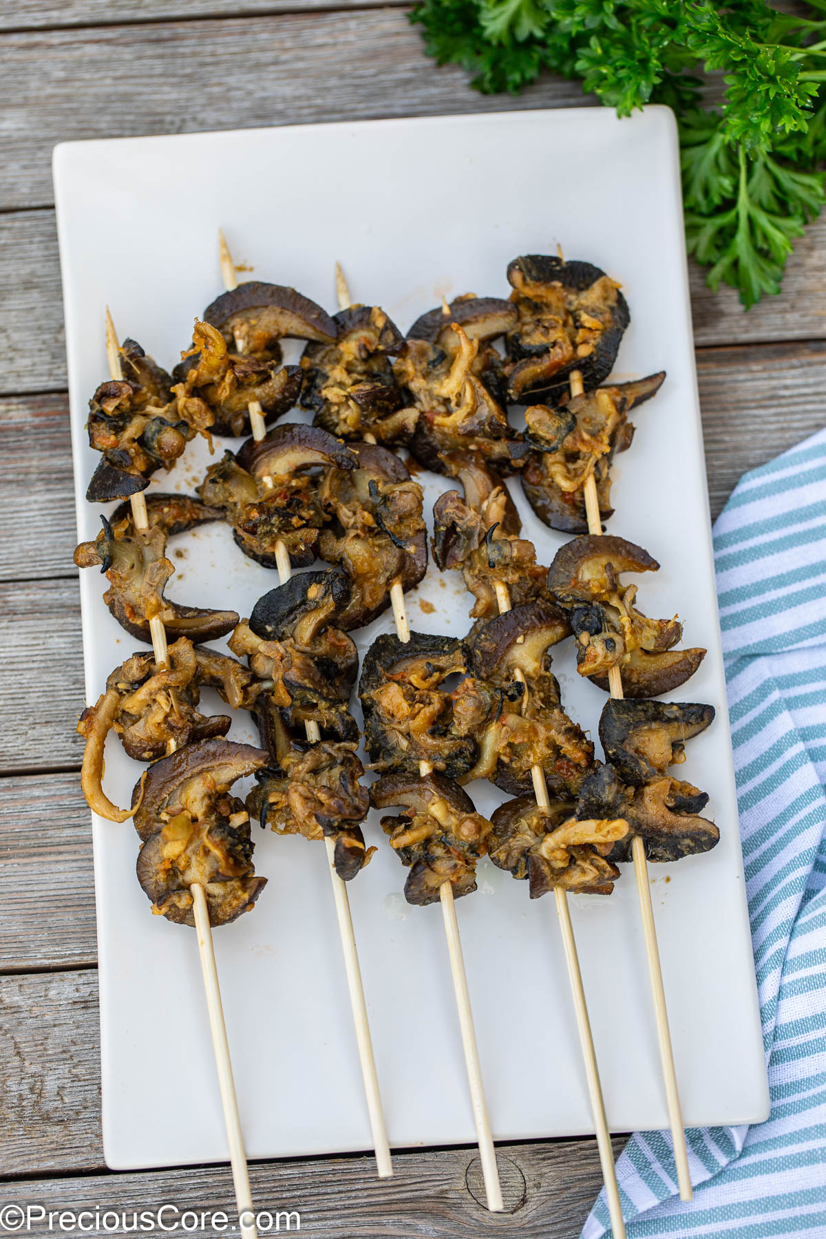 Cameroonian street food snails threaded on Bamboo skewers.