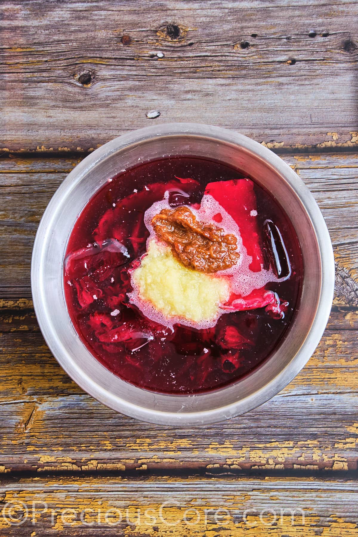 Pineapple and date puree added to a pot of hibiscus tea.