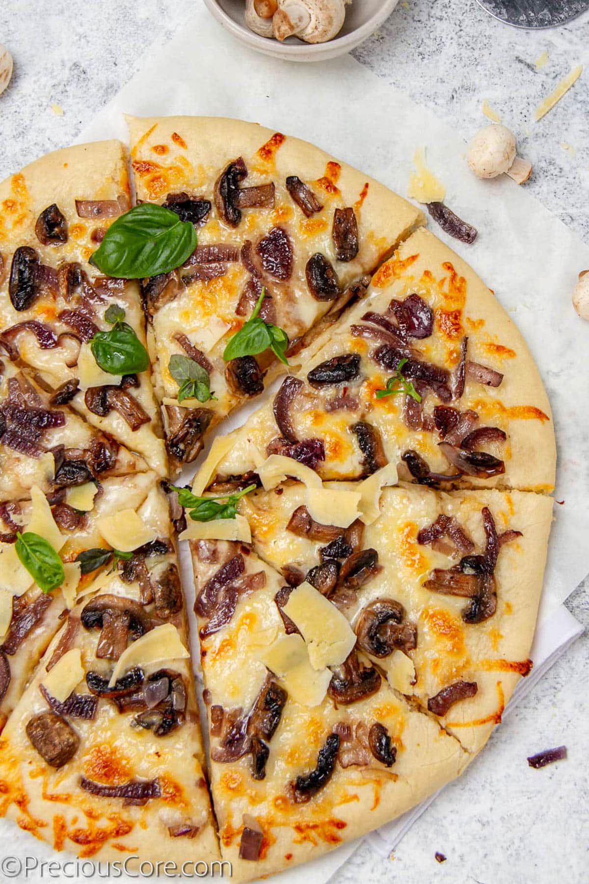 Pizza topped with mushrooms and fresh basil.