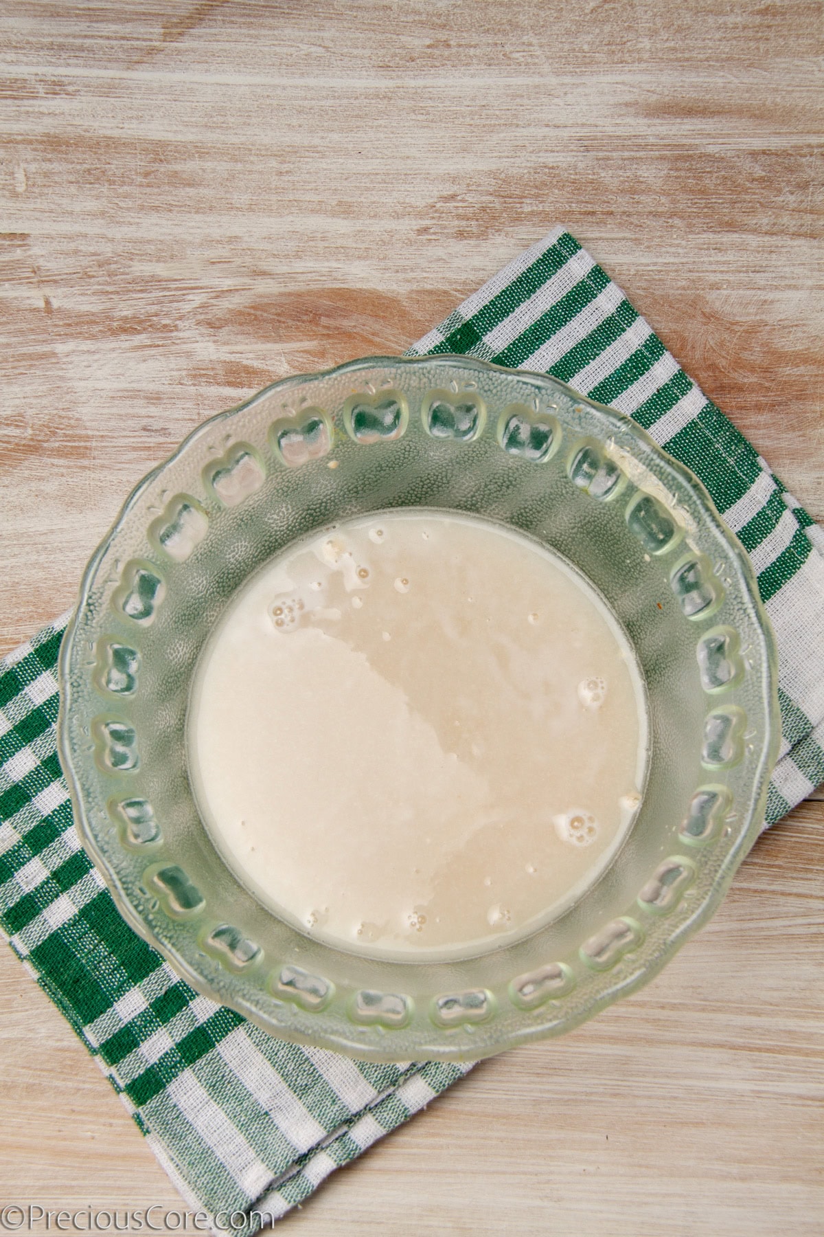 Yeast dissolved in a bowl of warm water.