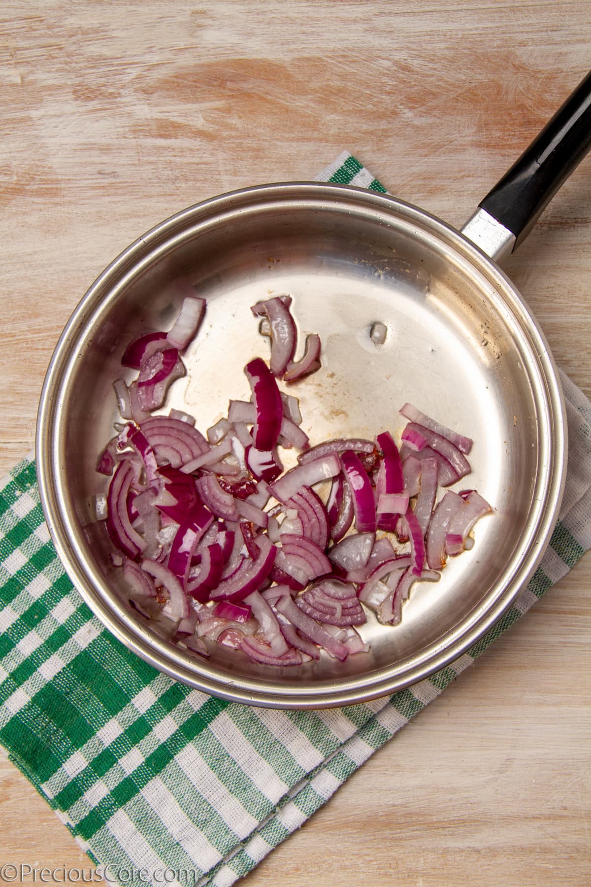 Sautéing onions in a pan.