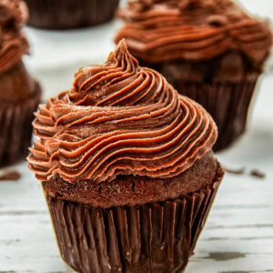 Close-up of a chocolate cupcake topped with a chocolate buttercream frosting.