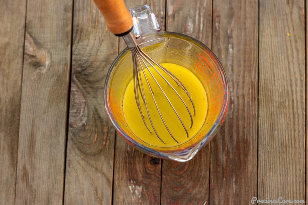 Simple lemon vinaigrette in a measuring cup.