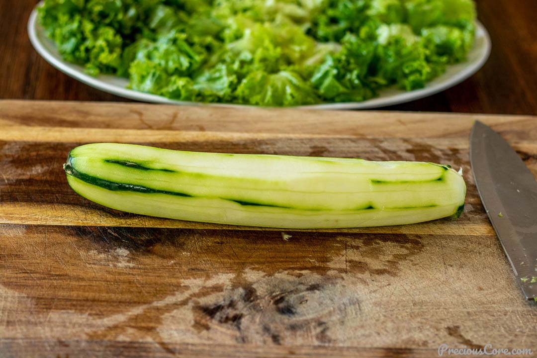 Peeled garden cucumber on a chopping board.