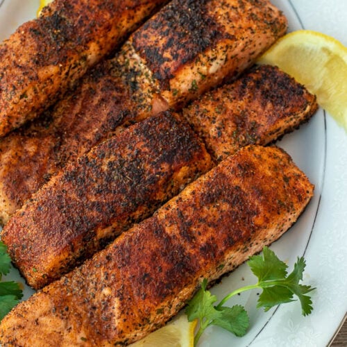 Grill pan with delicious salmon steaks on stove in kitchen Stock