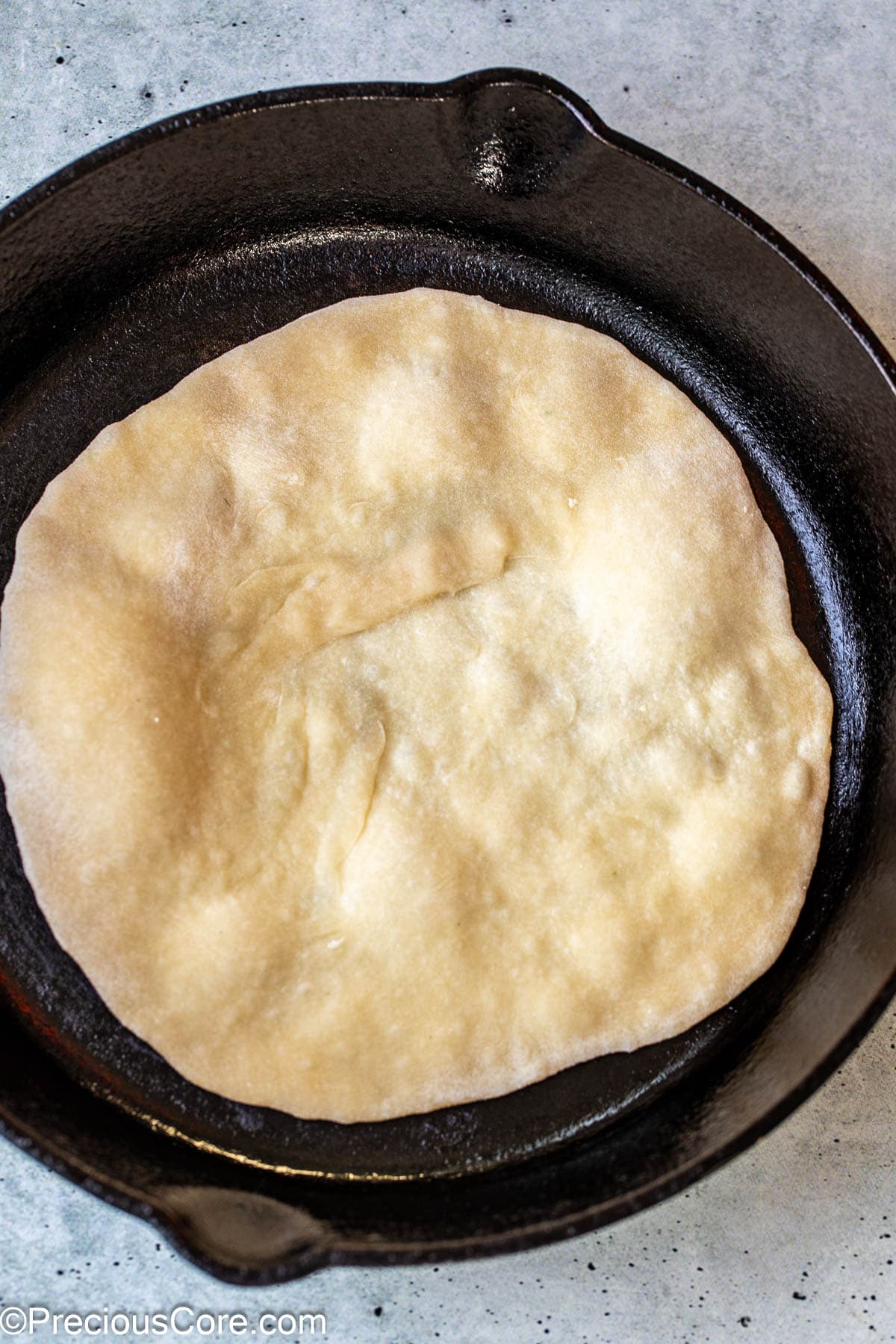 Shawarma bread cooking in a skillet.