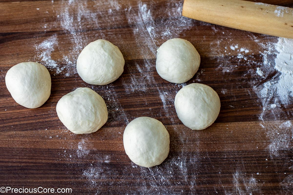 Divided dough shaped into 6 balls.