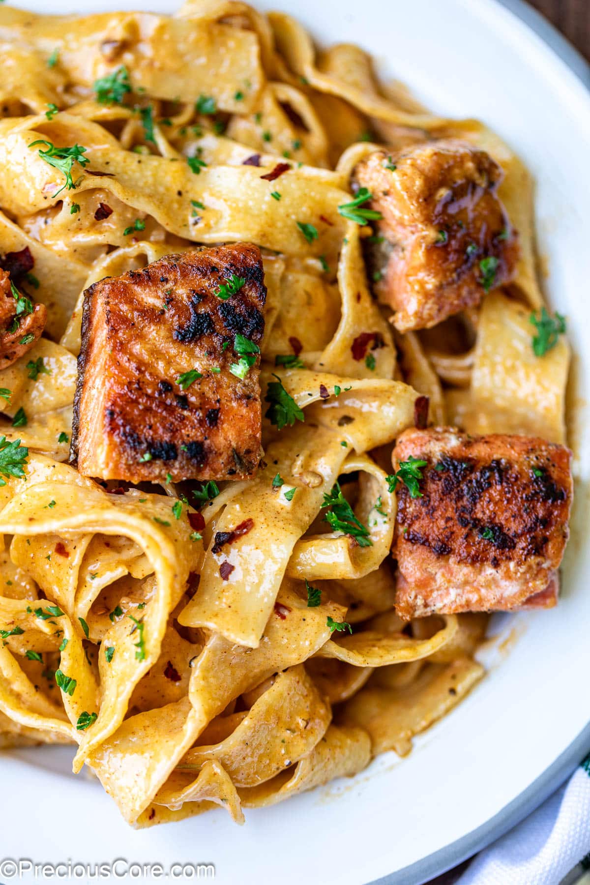 Cajun Pasta with Salmon with fresh parsley.