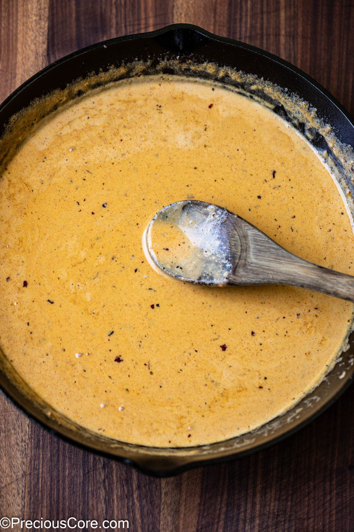 Stirring homemade creamy cajun pasta sauce.