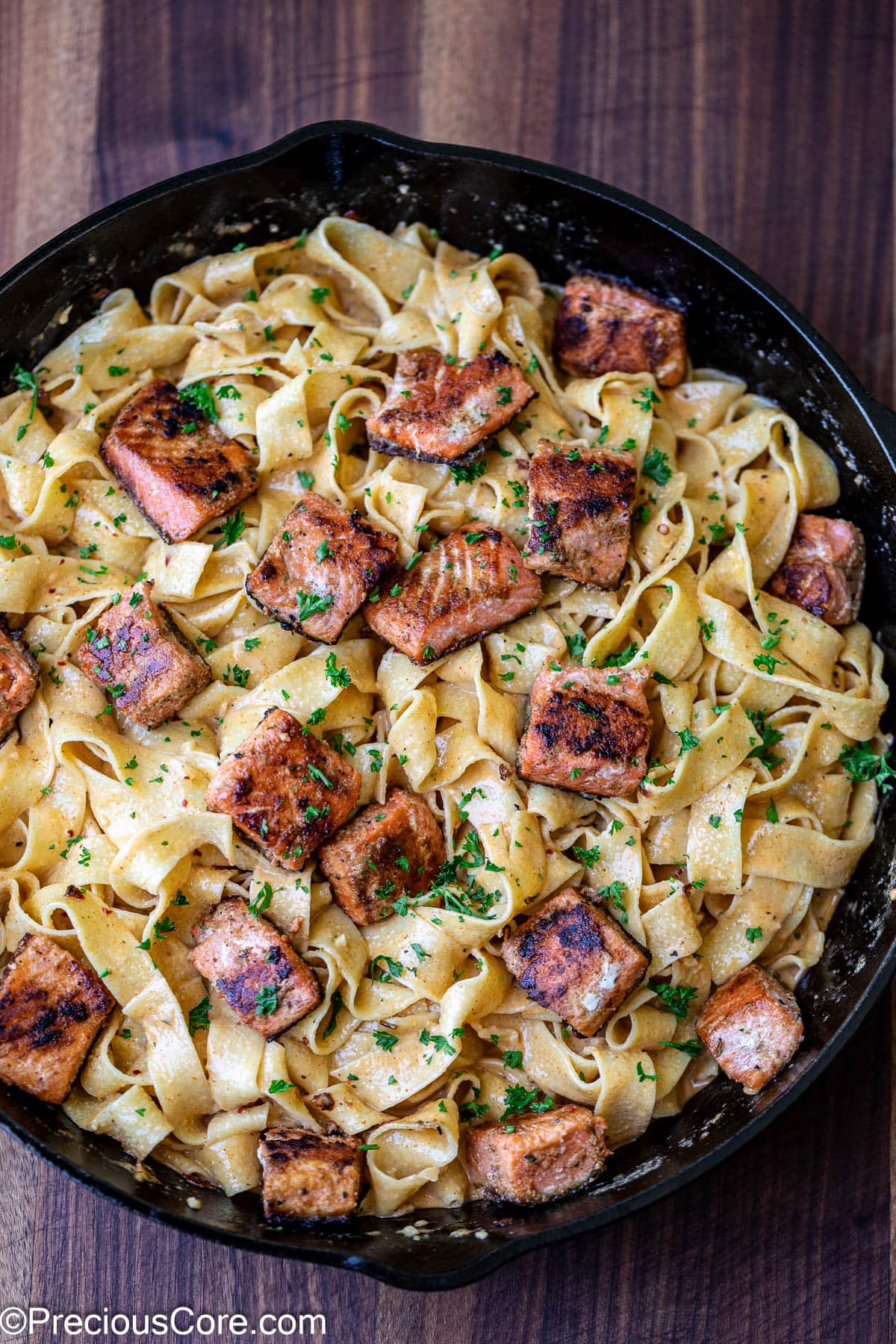 Cajun pasta with salmon pieces added.