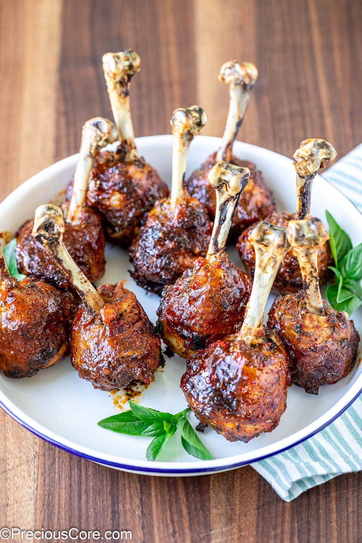 Plate of baked and glazed chicken lollipops.