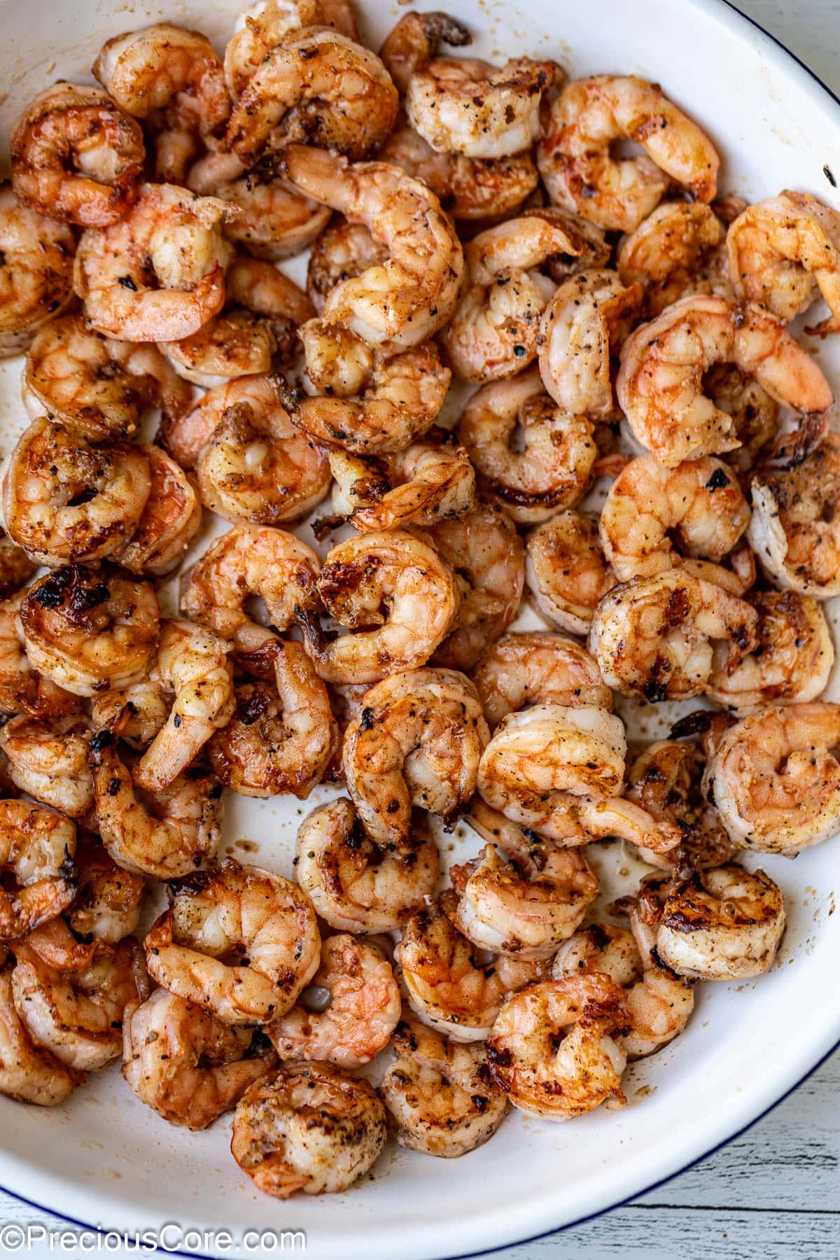 Seasoned and cooked shrimp in a bowl.