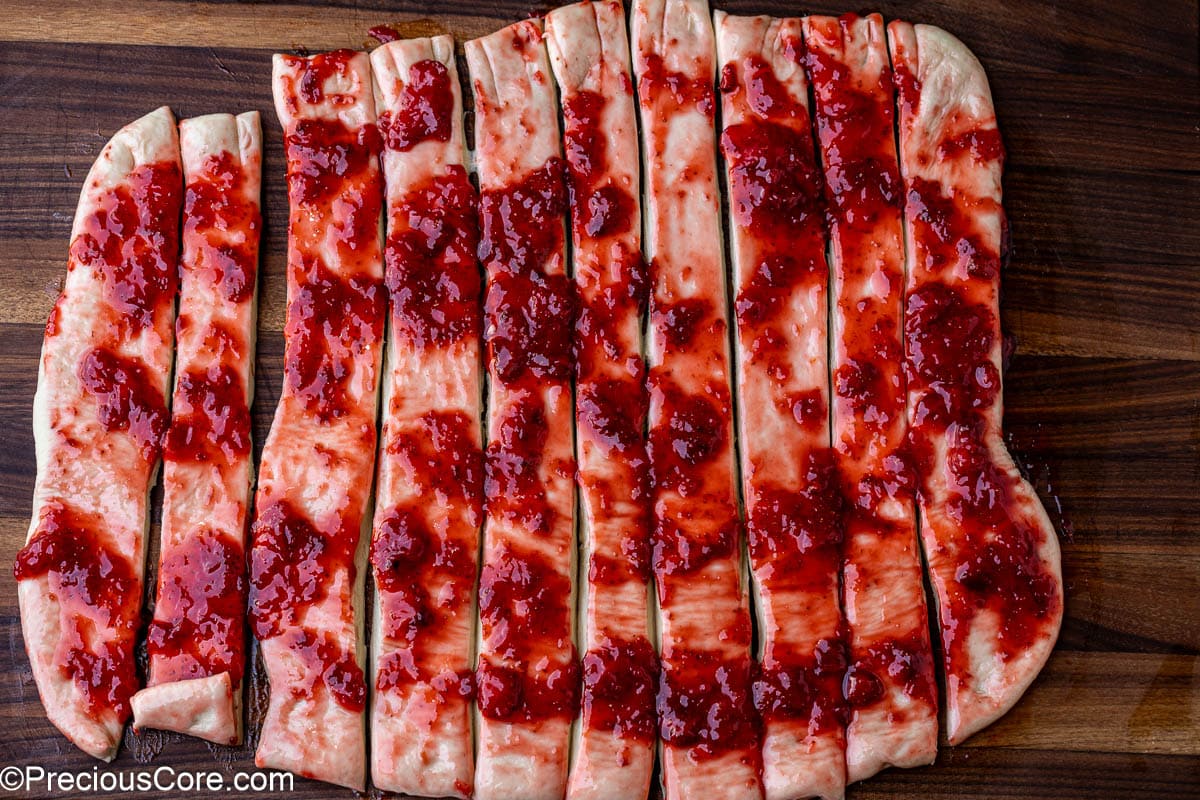 Cinnamon roll dough cut into strips.