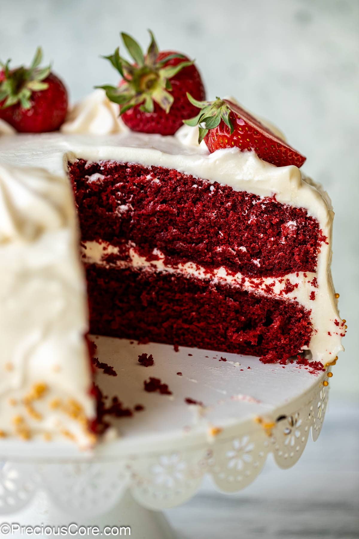 Cake cut open to show red velvet cake texture.