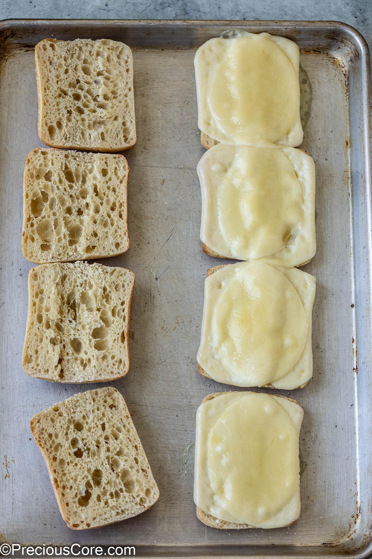 Toasted bread with melted cheese slices.