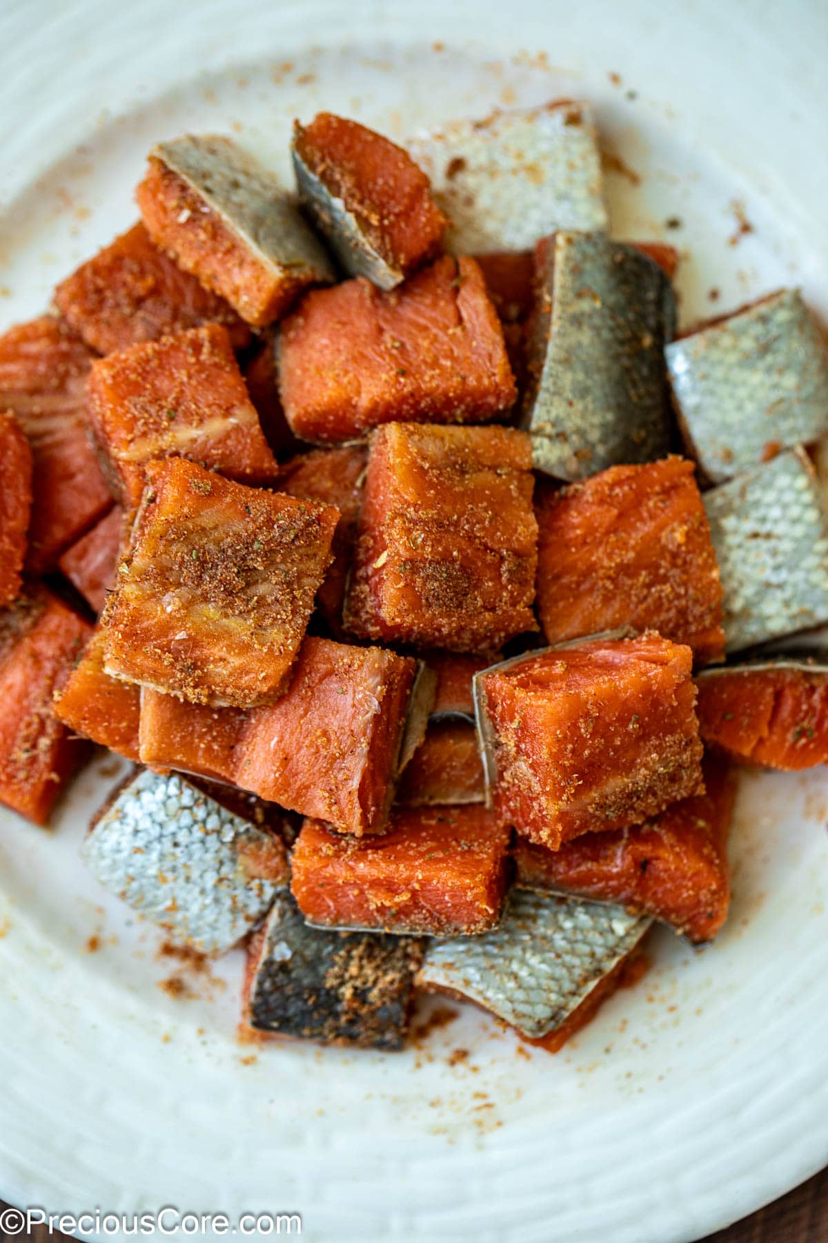 Raw salmon seasoned with spices.