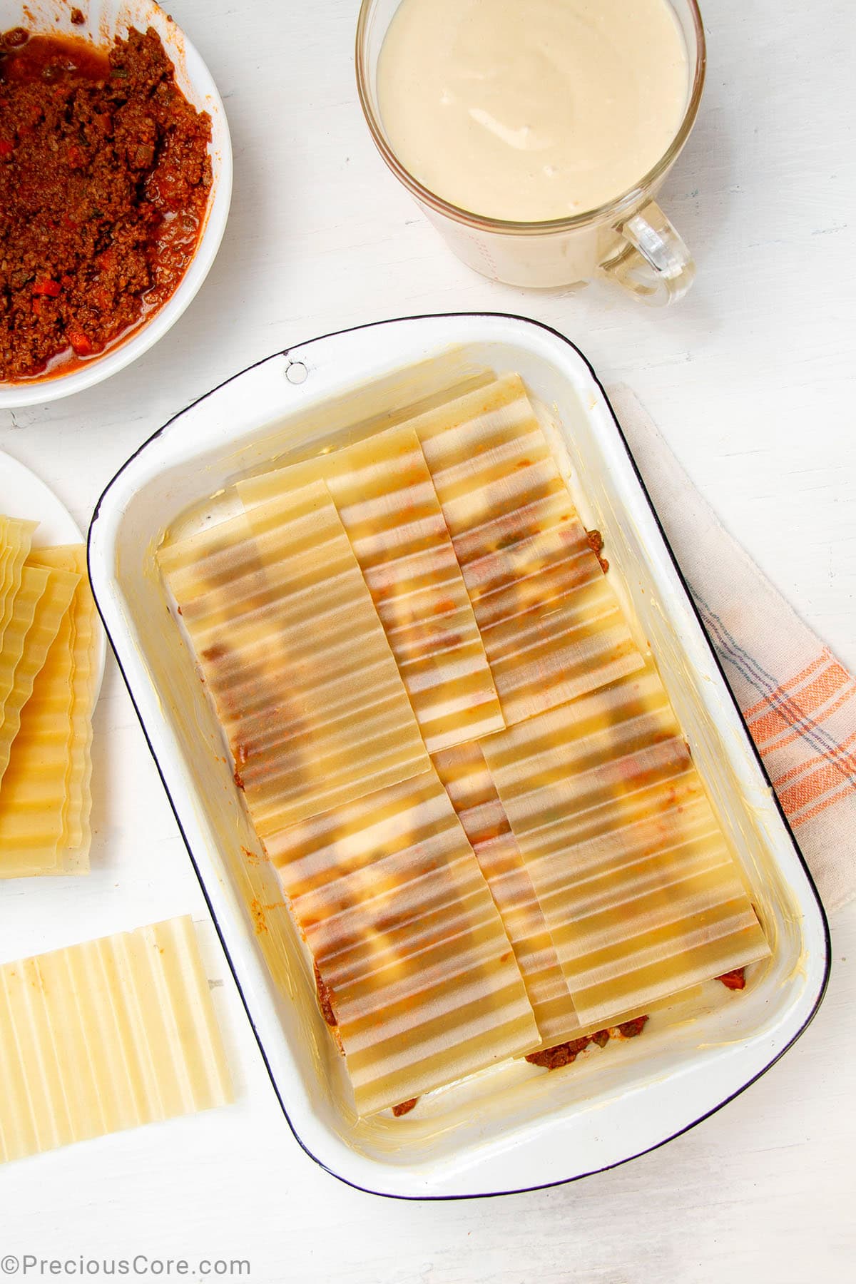 No-boil lasagna noodles layered over meat sauce.