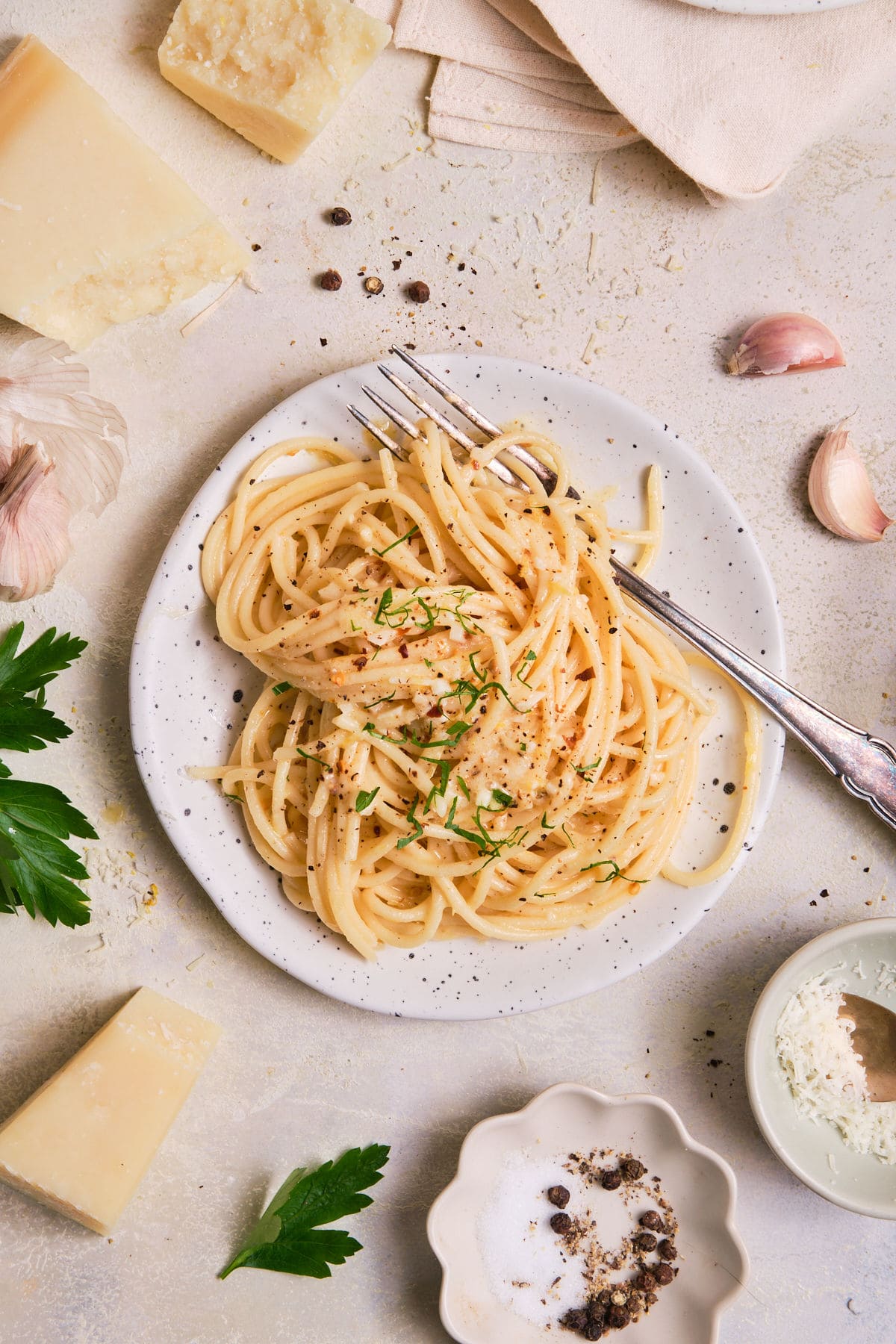 Pasta on a plate with ingredients nearby.