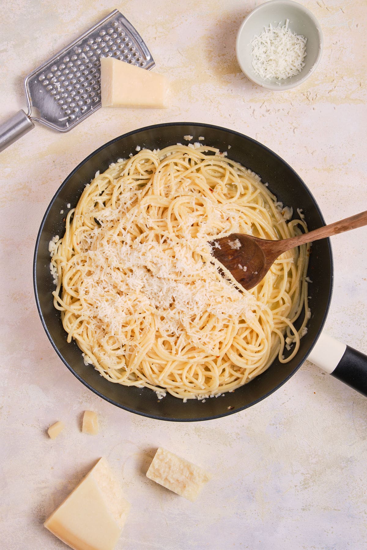 Parmesan added to lemon garlic butter pasta.