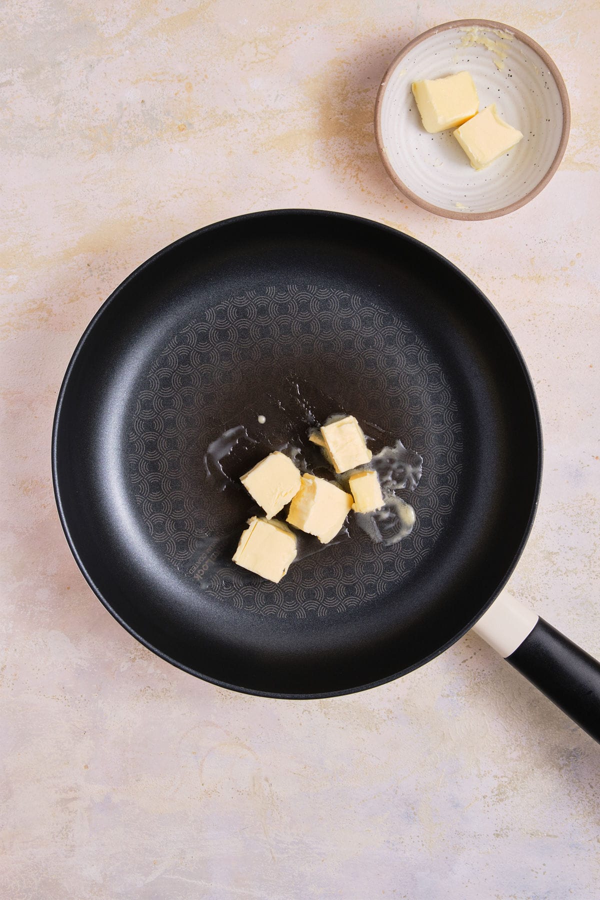 Butter melting in skillet.