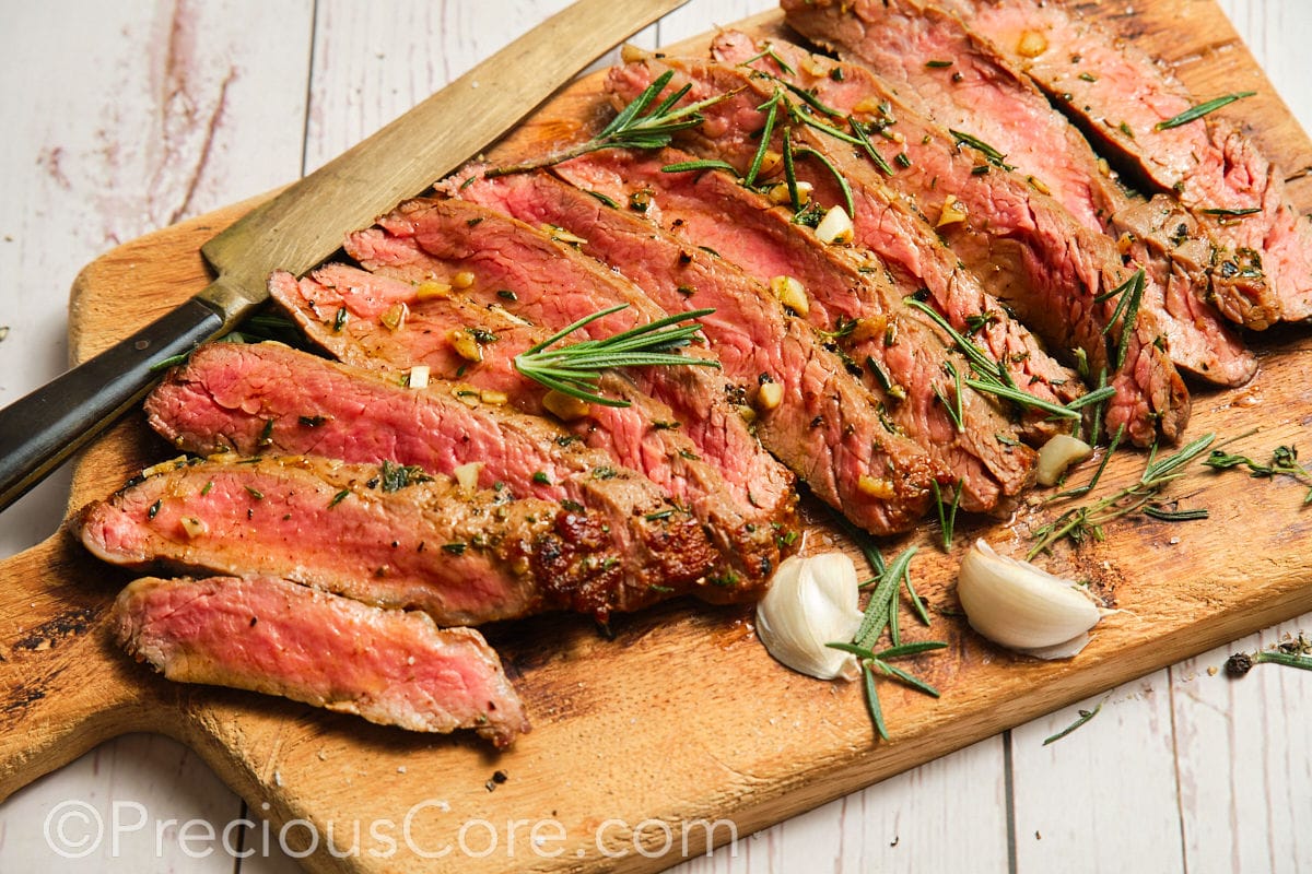 Wide shot of flank steak on cutting board.