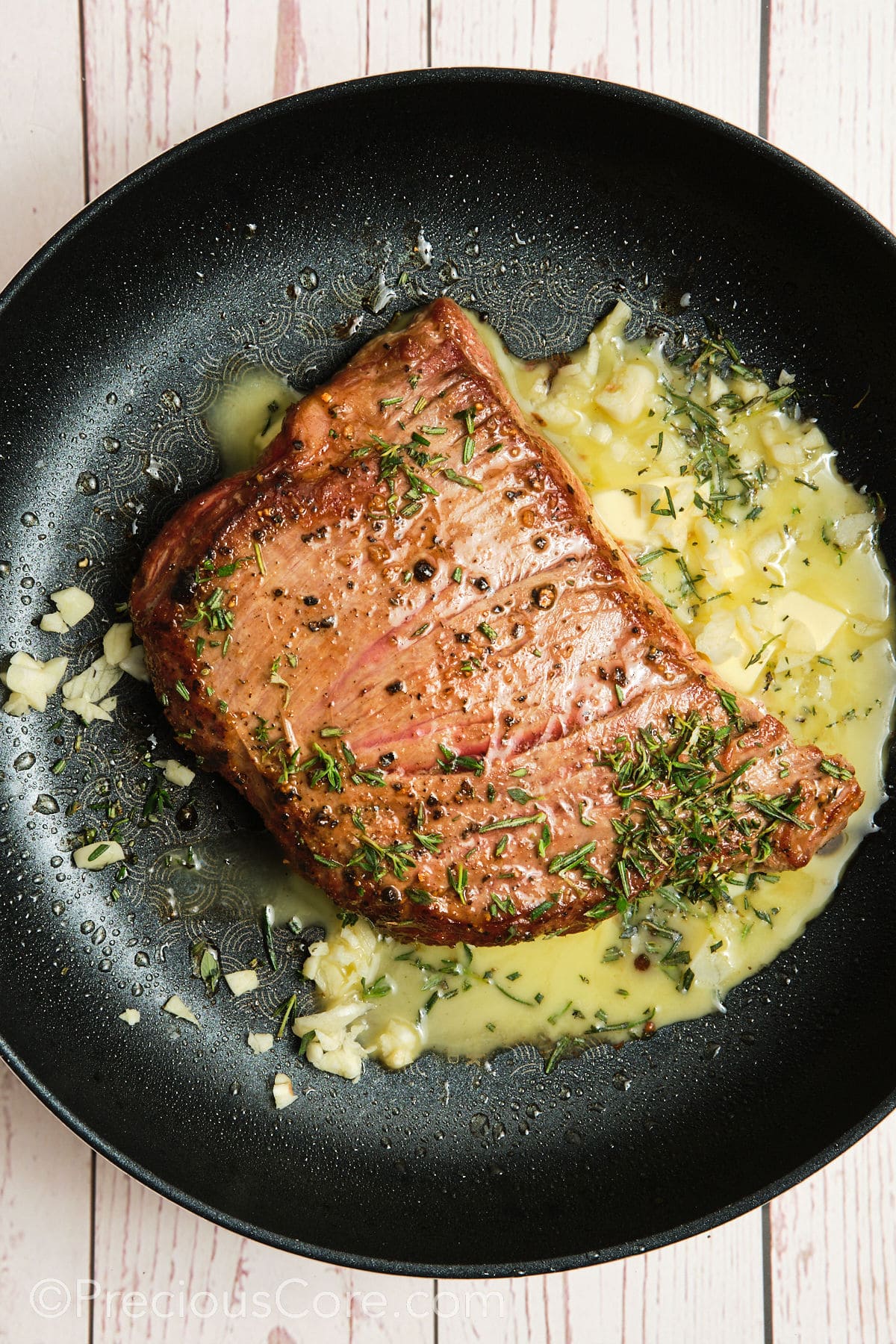 Butter added to pan with steak.