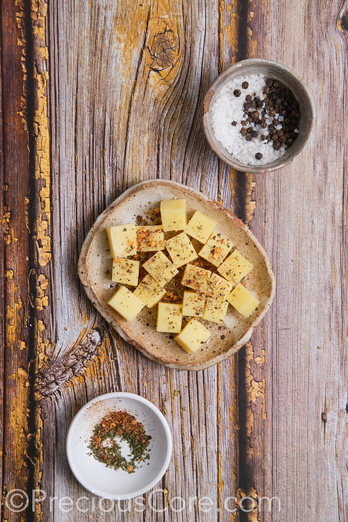 Seasoned cheese cubes on a plate.