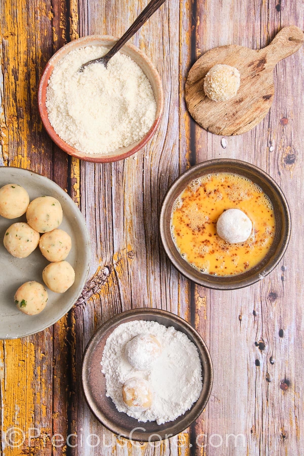 Egg mixture, flour on a plate, and breadcrumbs for potato cheese balls coating.