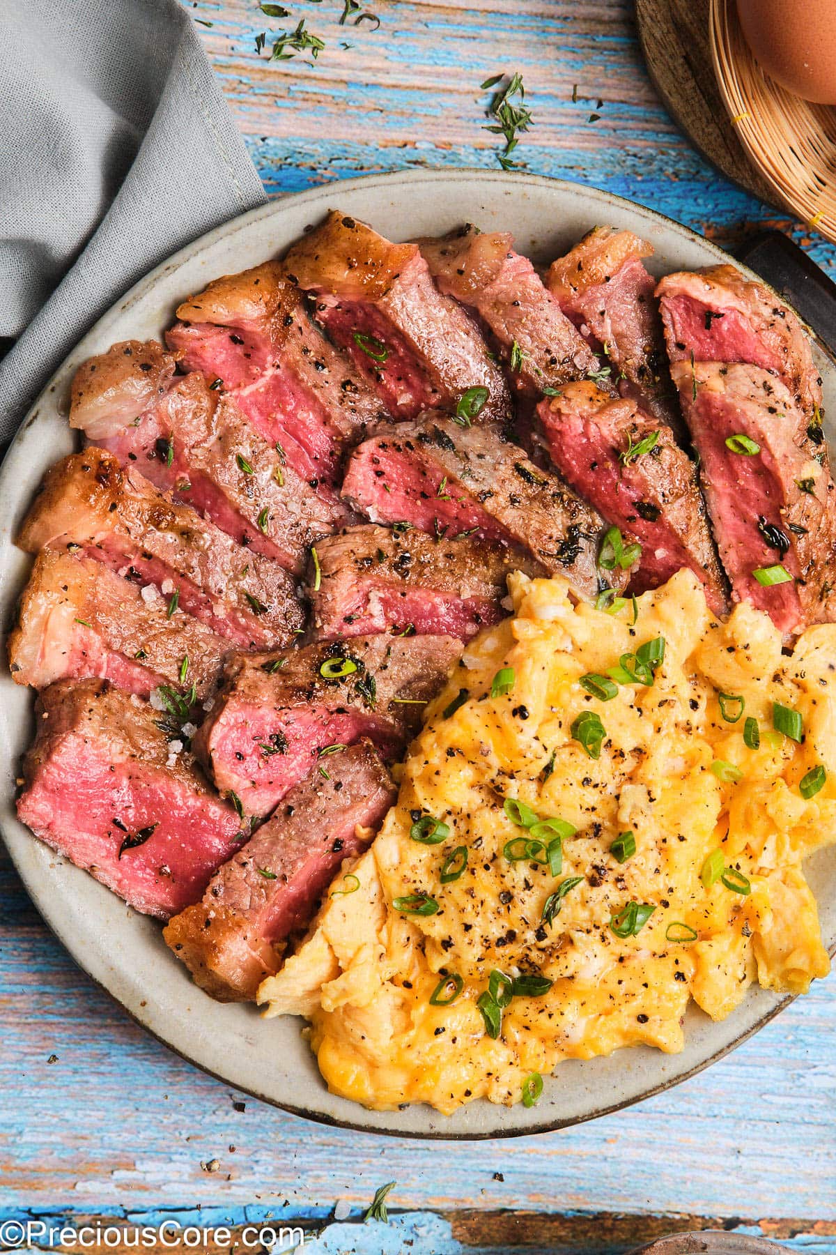 Close-up of Steak and Scrambled Eggs on a plate.