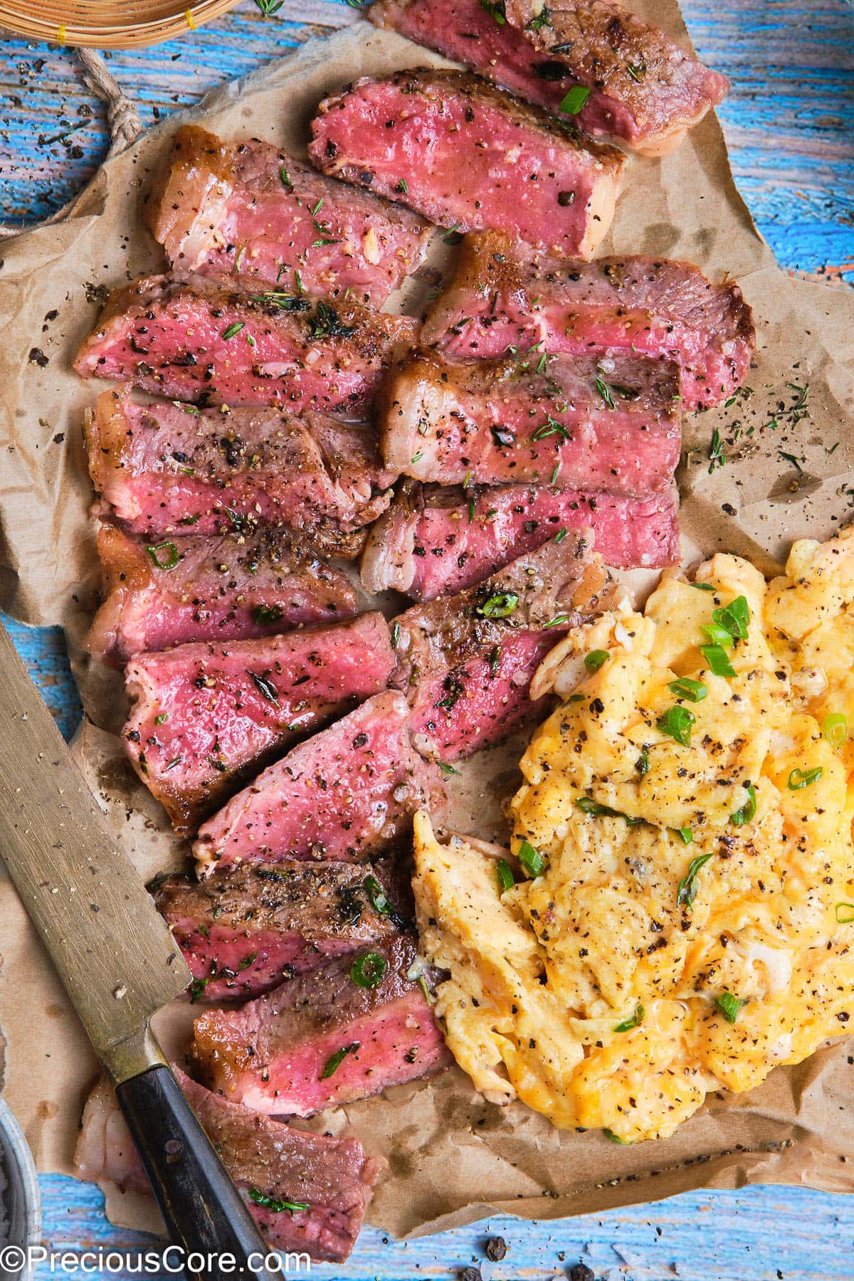 Slice juicy steak with soft scrambled eggs.