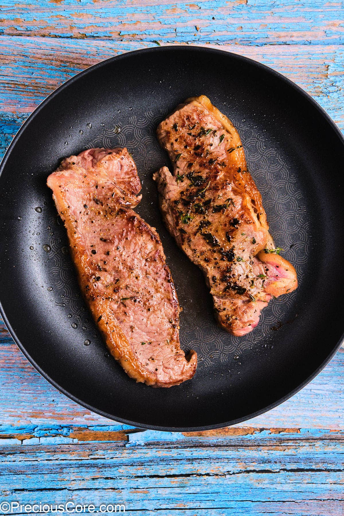 Seared steaks in a skillet.