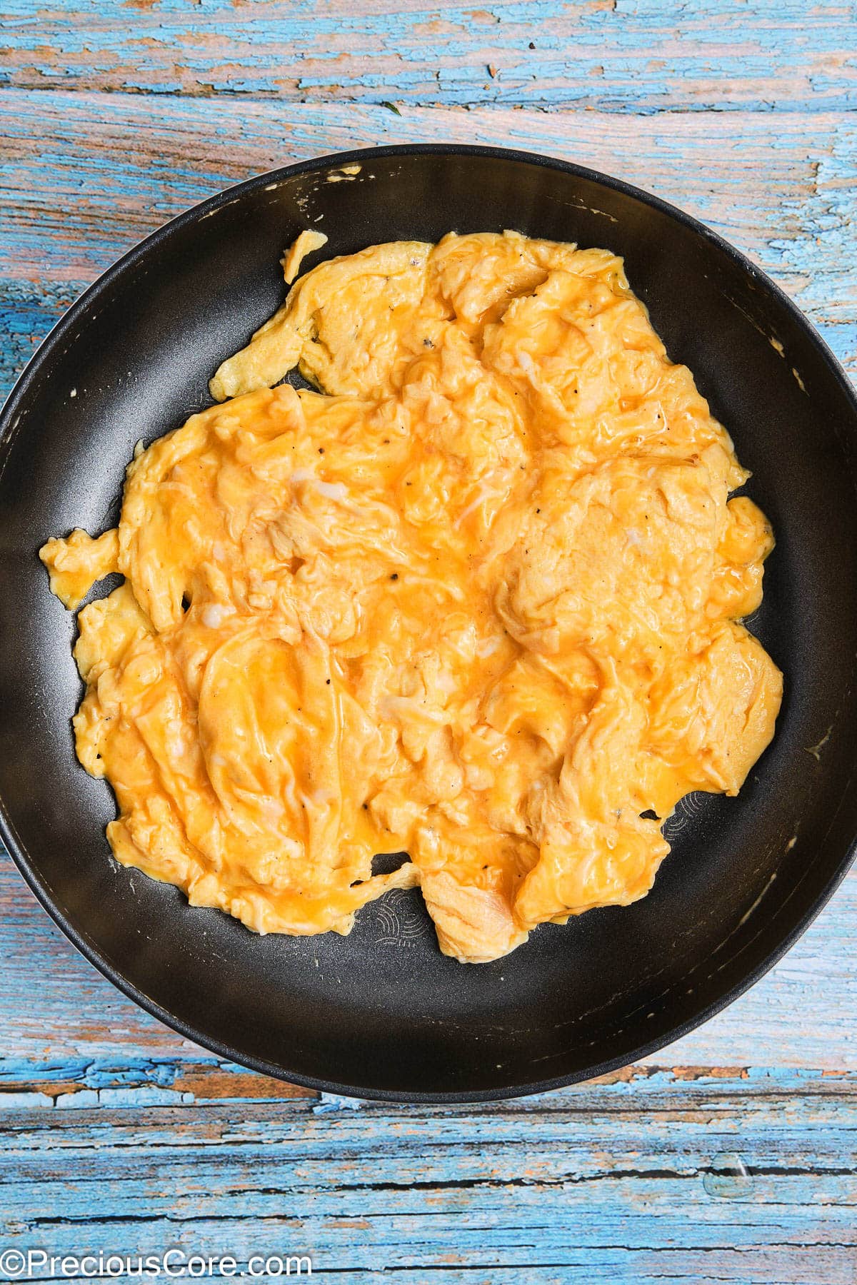 Soft scrambled eggs in a skillet.