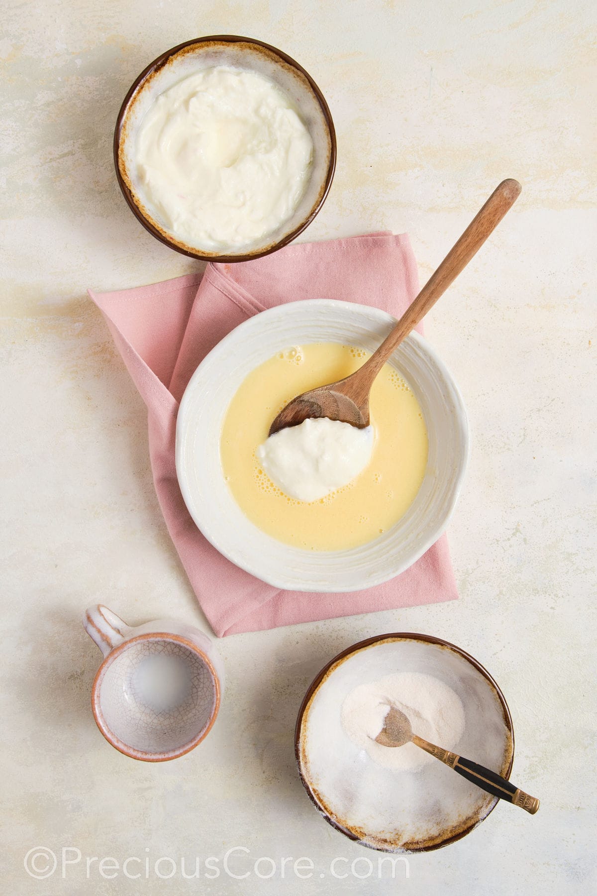 Greek yogurt being added to pudding mix.