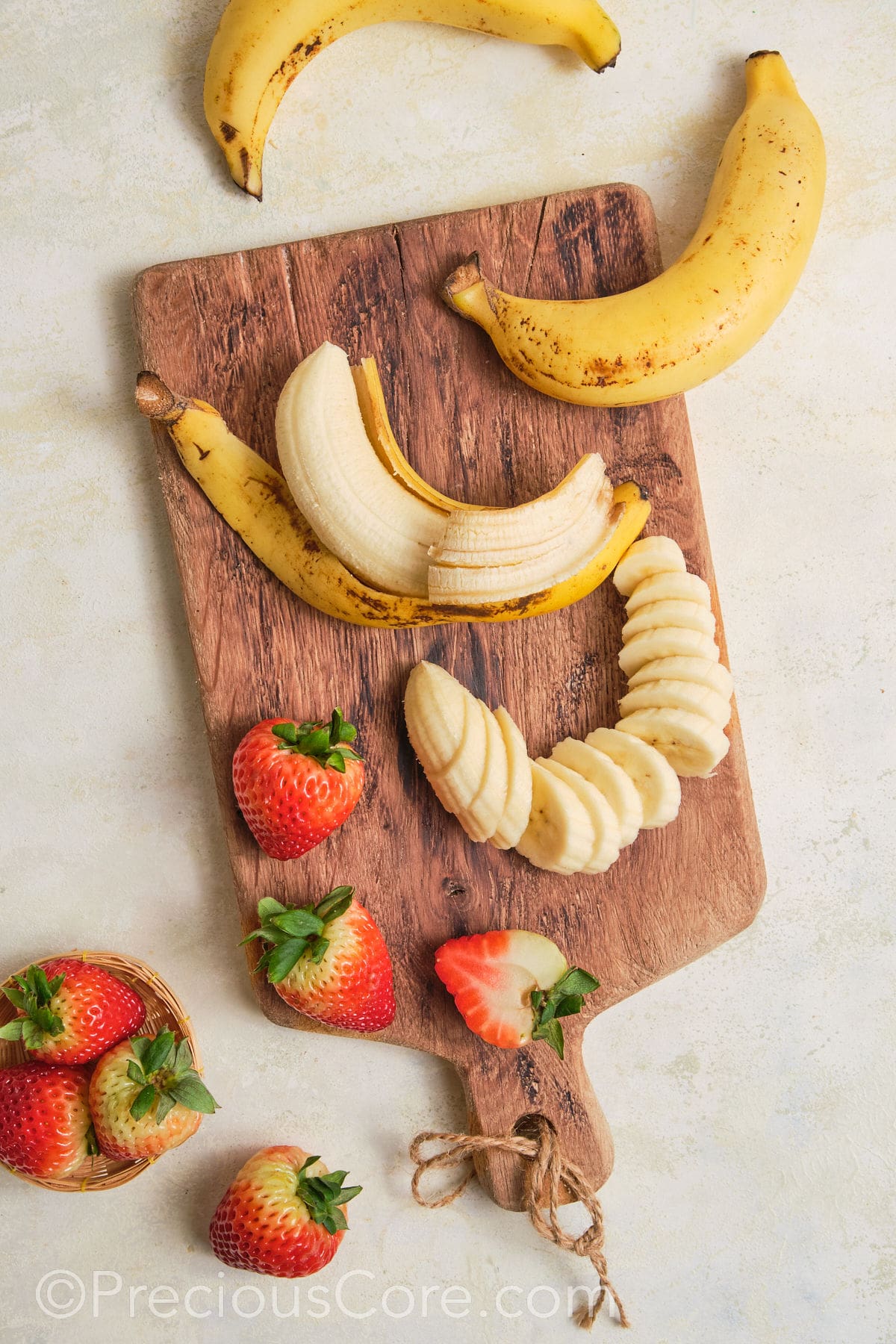 Slicing bananas and strawberries for banana pudding.