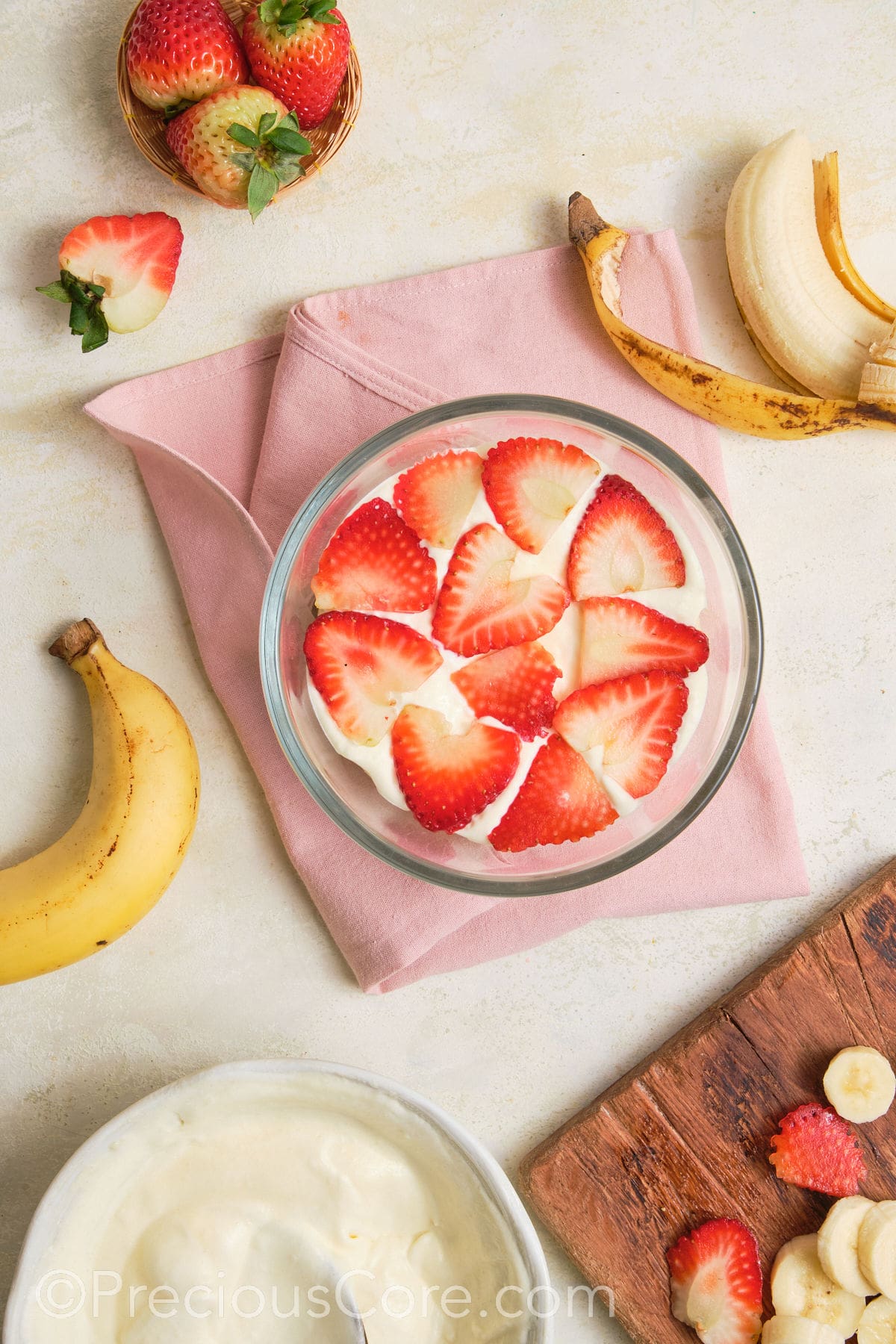 Sliced strawberries added to pudding.