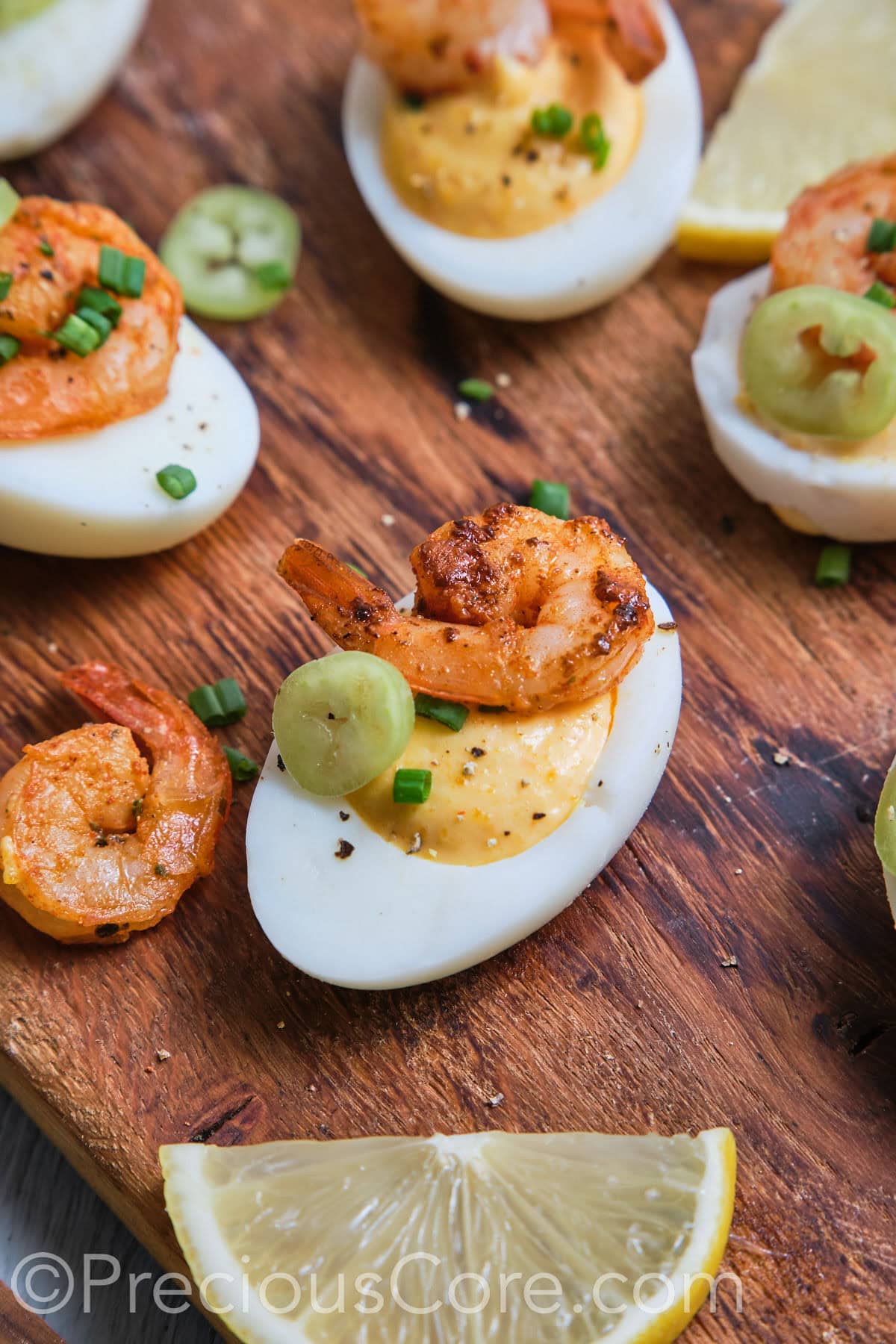 Close-up of a deviled egg topped with shrimp.