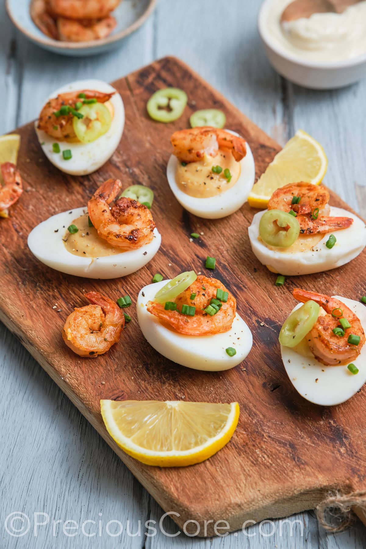 Side shot of delicious-looking deviled eggs topped with shrimp.