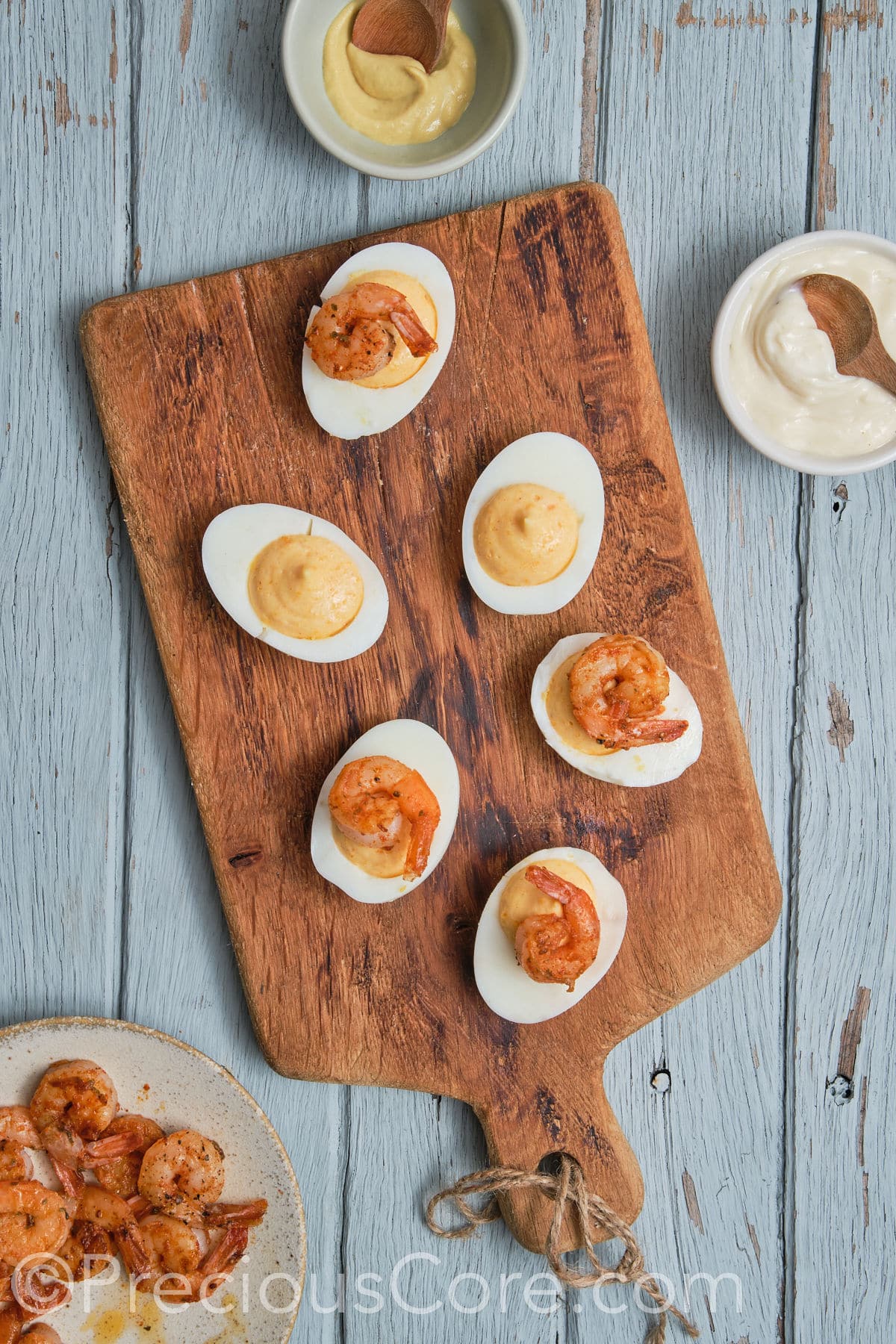 devilled eggs topped with shrimp.