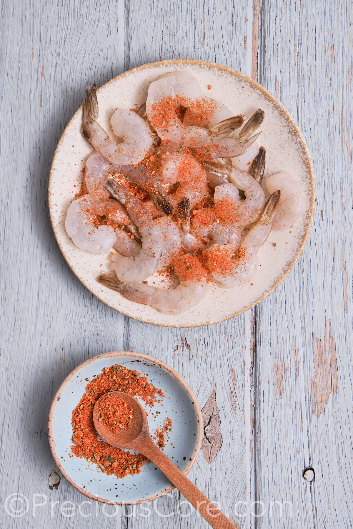 Seasoning shrimp on a plate.