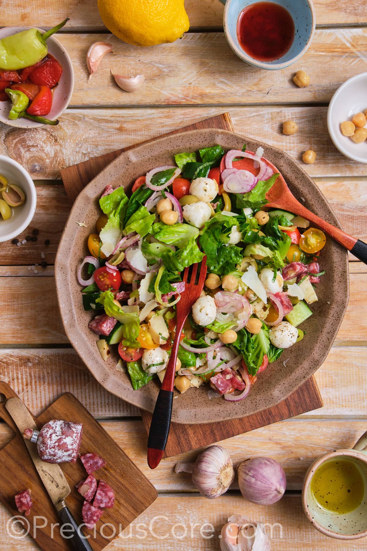 Mixing Italian Chopped Salad in a bowl.