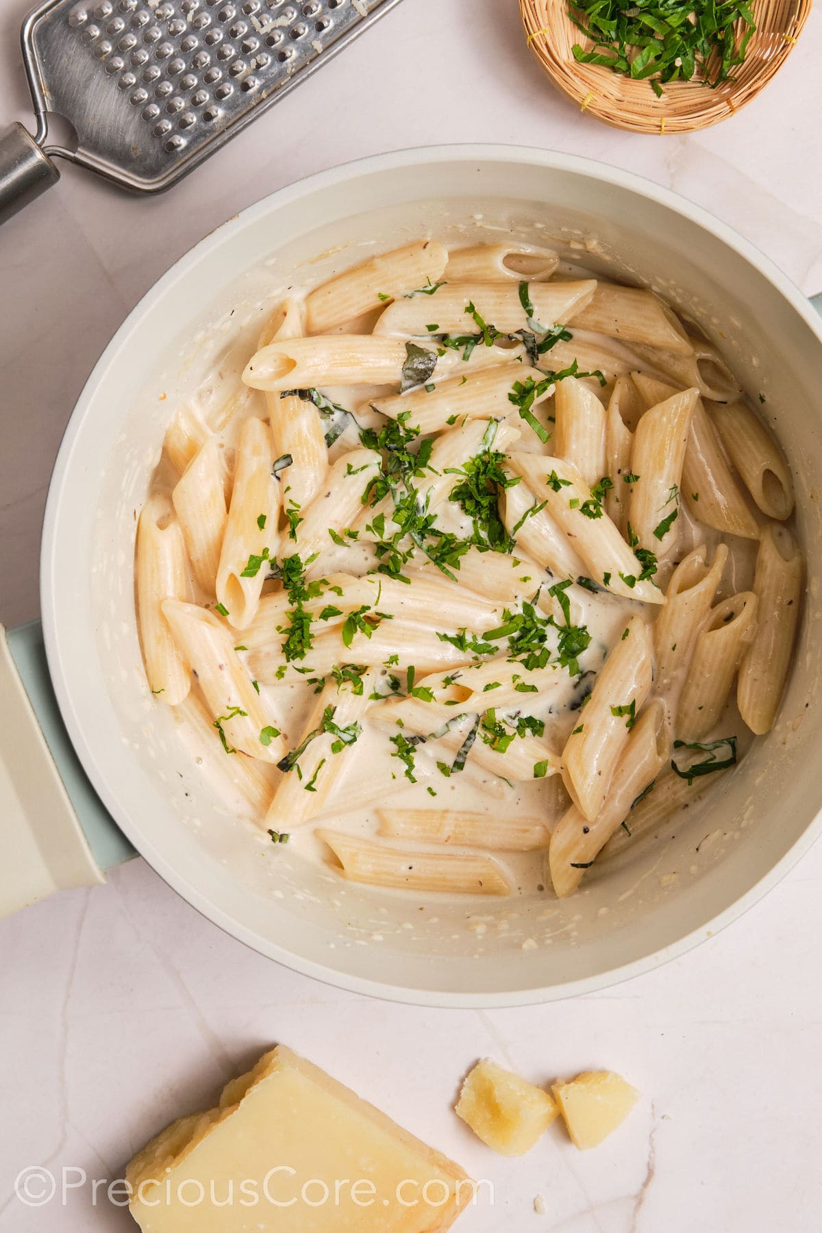 Basil and parsley added to creamy pasta.