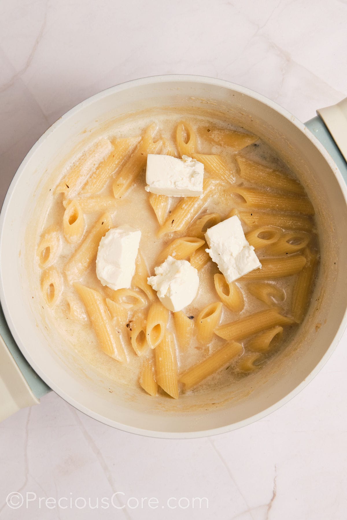 Cream cheese added to pasta.