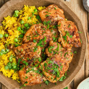 Pan Seared Boneless Chicken Thighs with yellow rice.