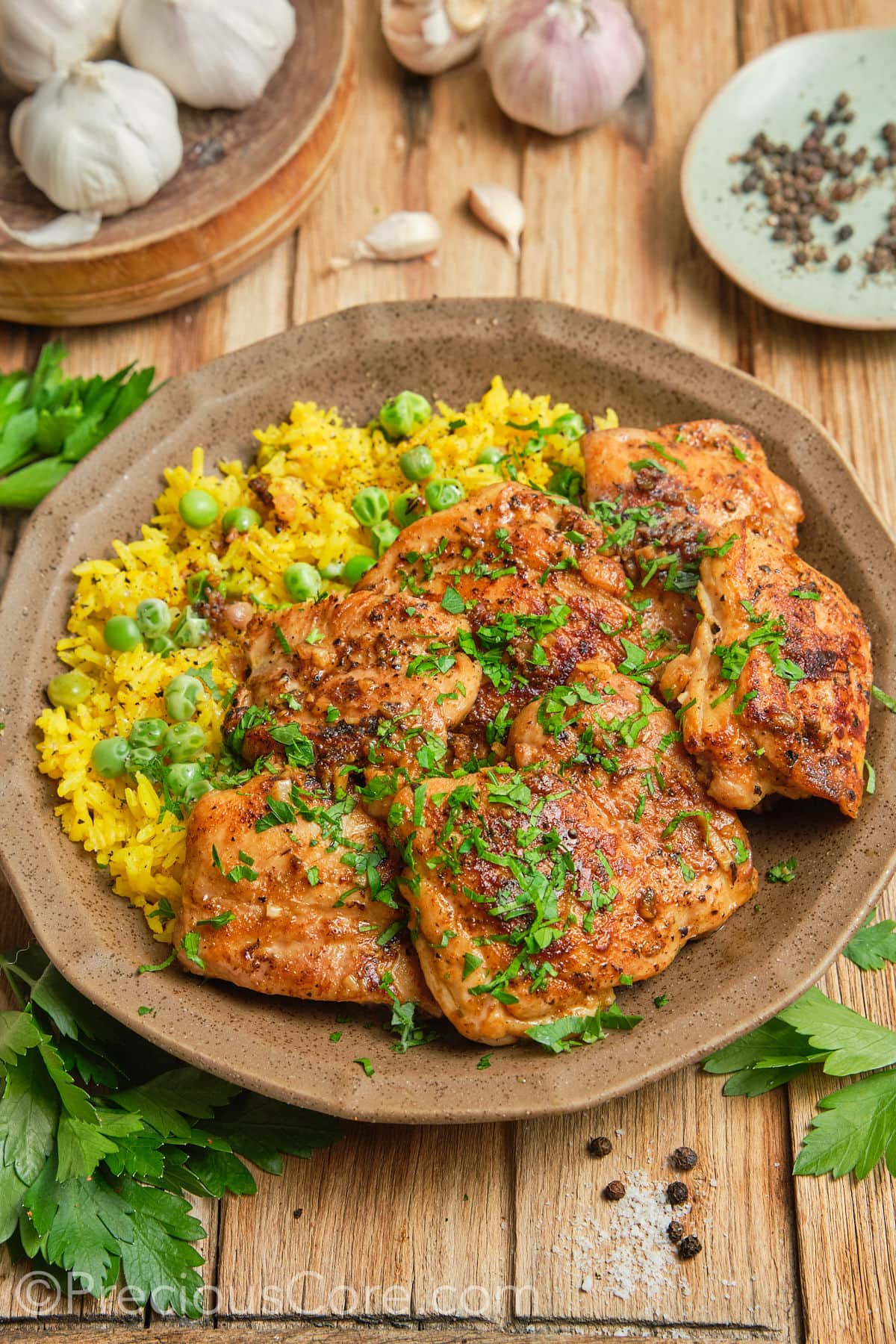 Seared chicken thighs with yellow rice.