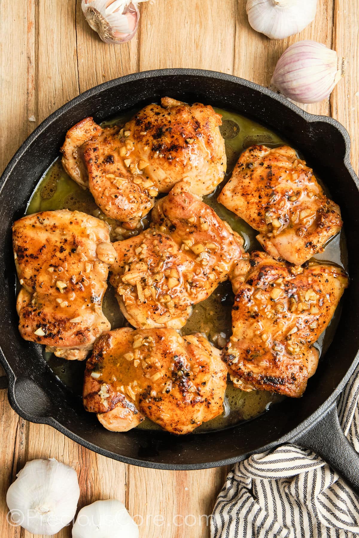 Cooked chicken thighs in a cast iron skillet.