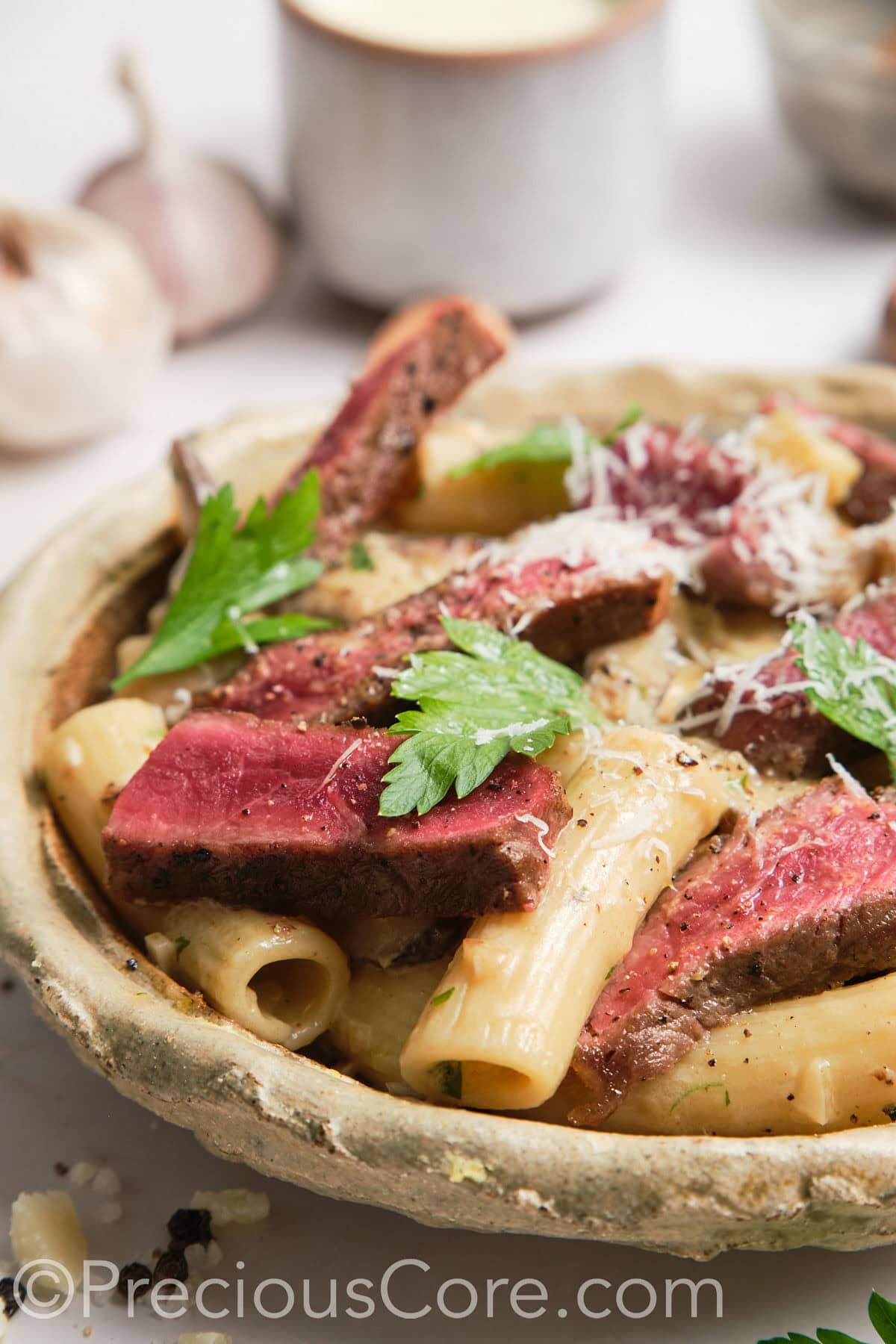 Close-up shot of steak and pasta.