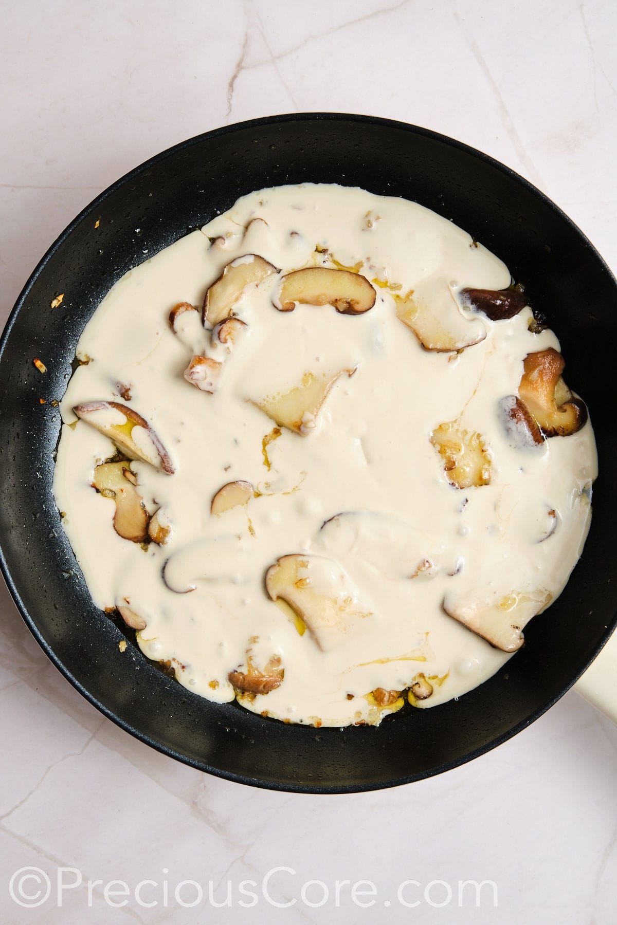 Creamy sauce added to mushrooms.