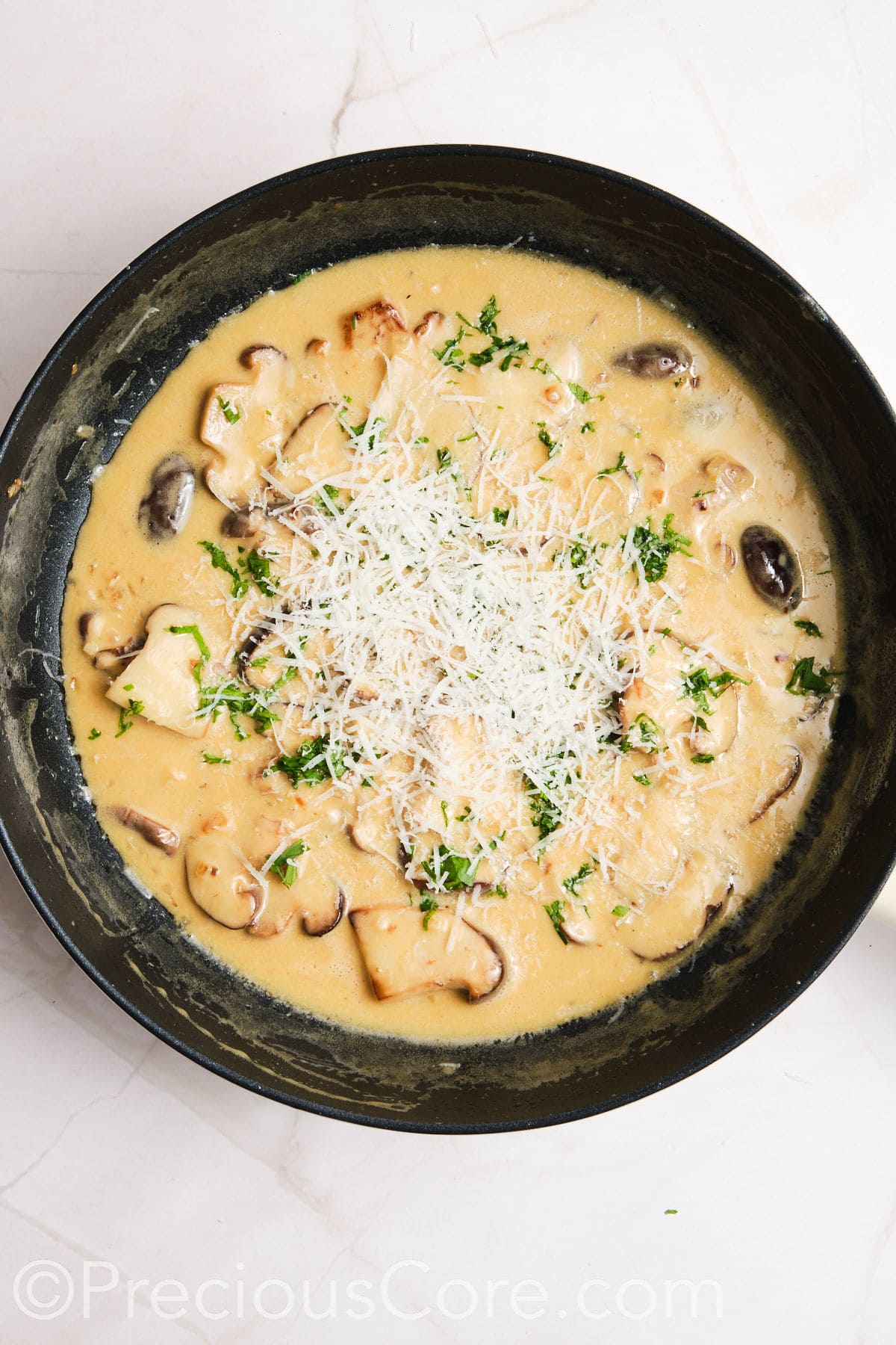 Parmesan added to creamy mushroom sauce.