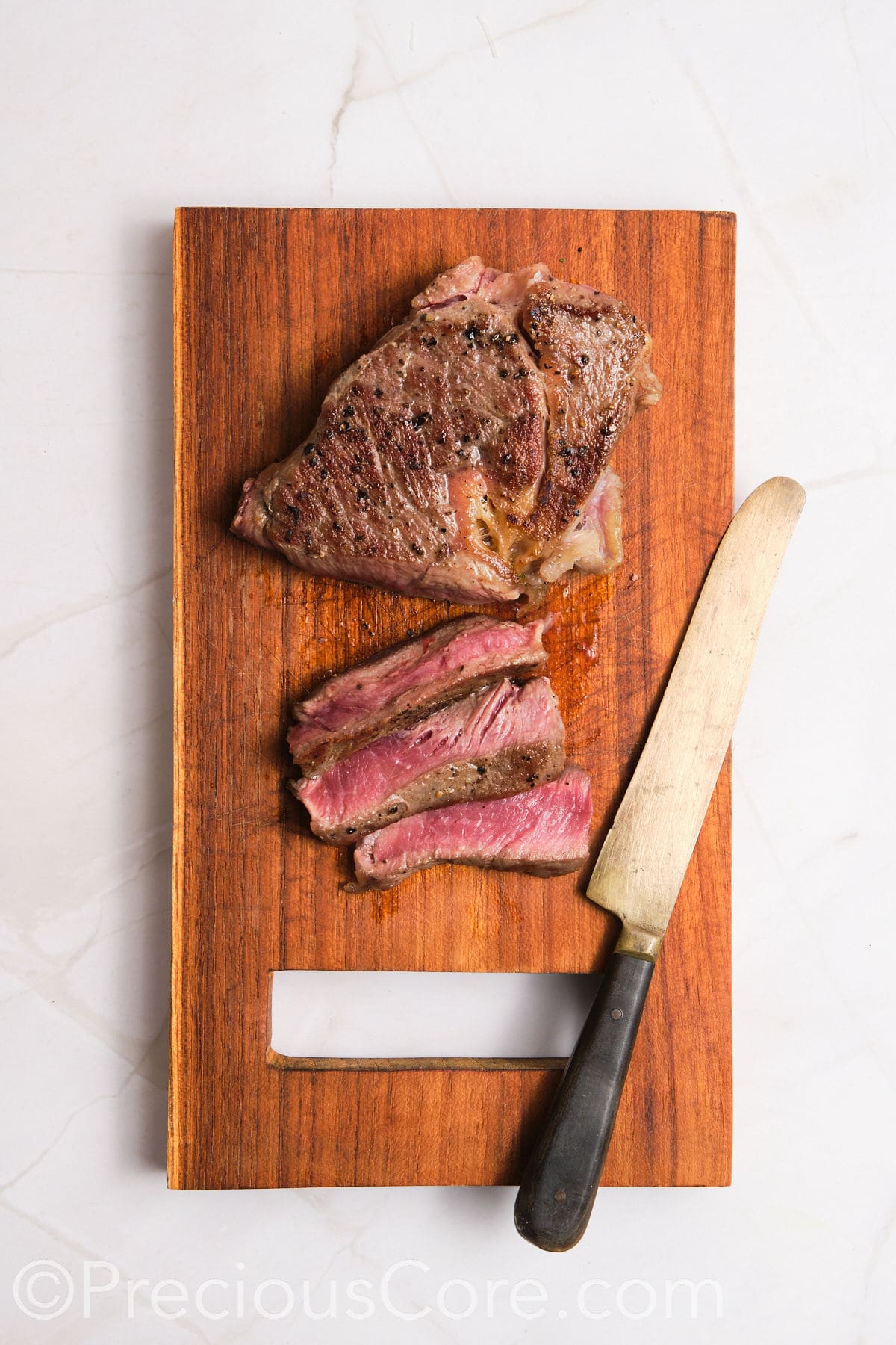 Slicing steak into thin strips.