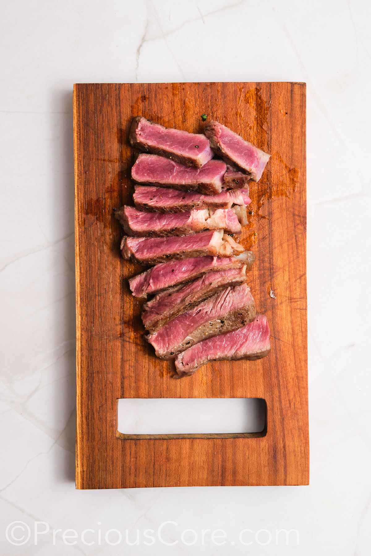 Steak sliced on a cutting board.